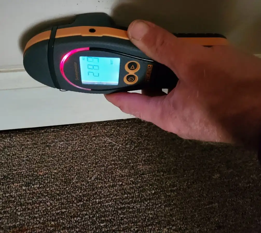 Moisture detection at baseboard during Storm Damage Restoration in Waterford